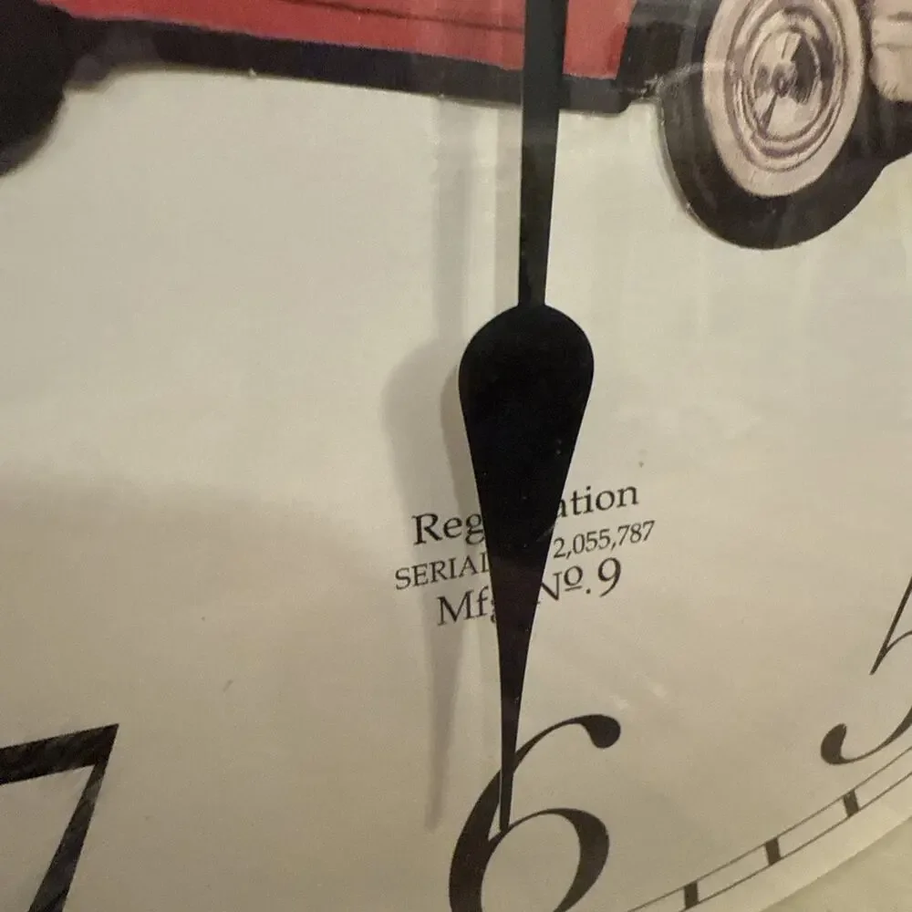 Sterling & NobleVNTGwall clock with a brown and gold ripple wood frame and a red